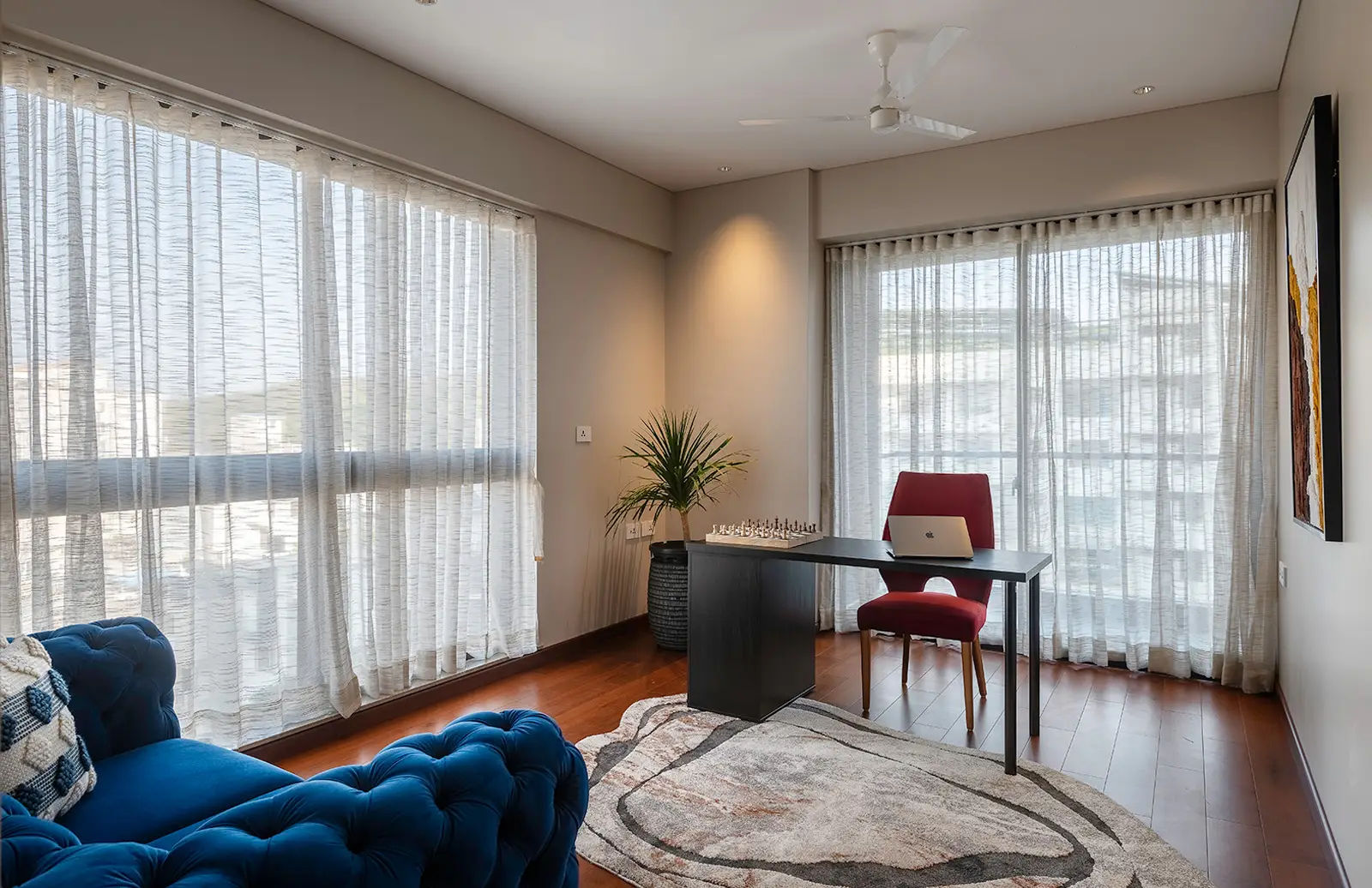 The study, with a desk set against floor-to-ceiling windows