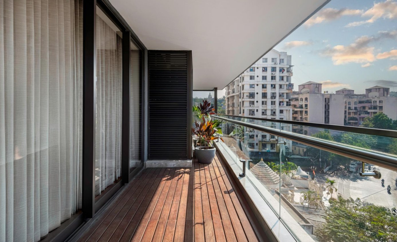 A private balcony running the length of the residence, glass railing open to the skyline