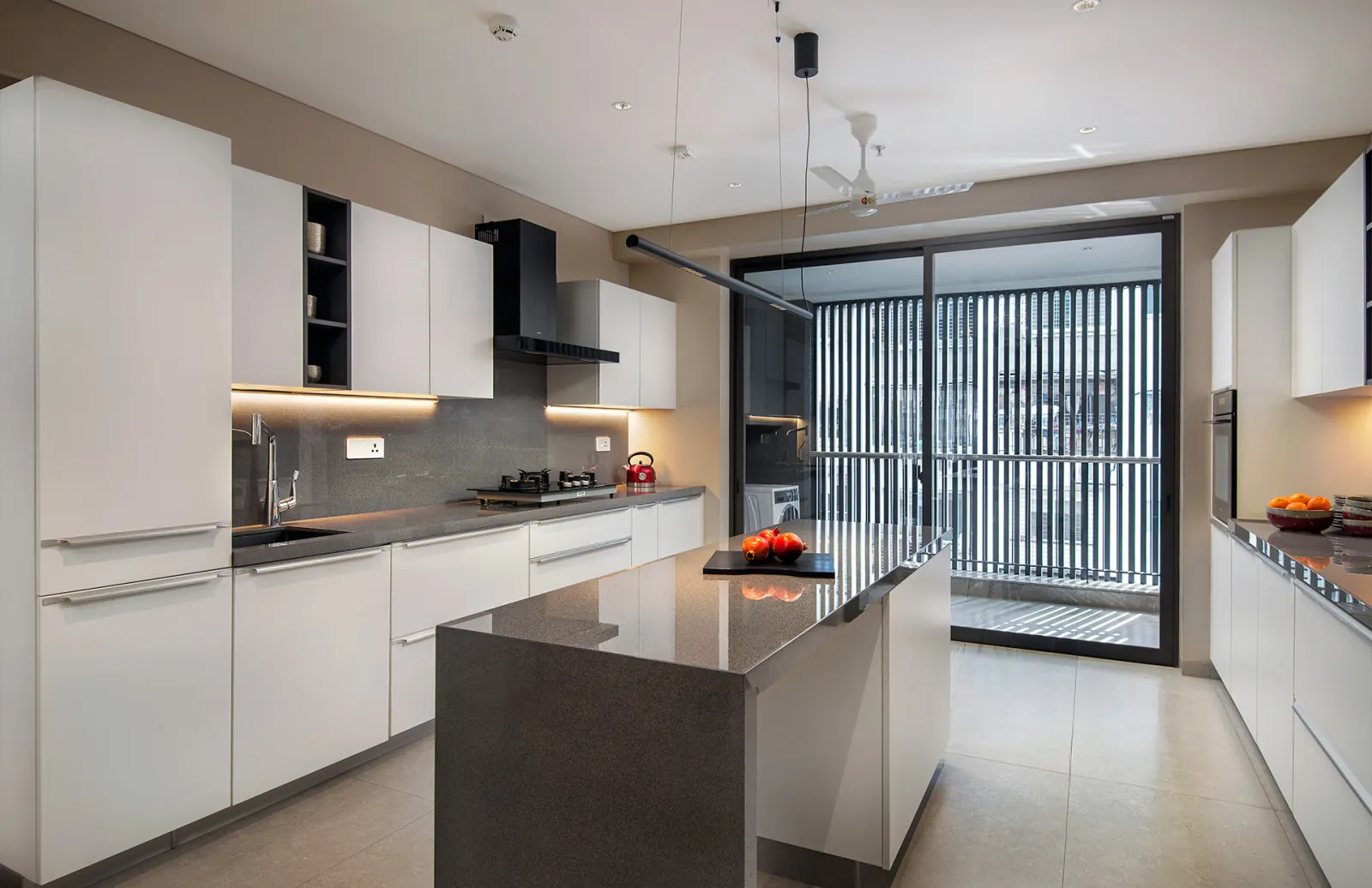 The kitchen, with a central island and full-height cabinetry