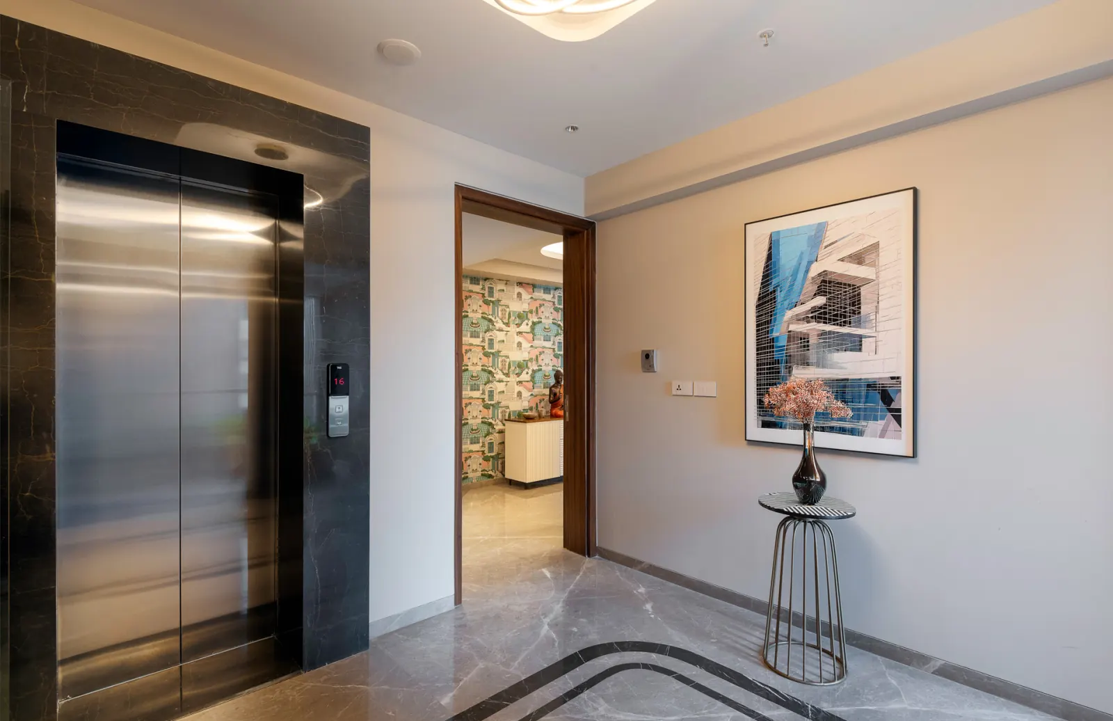 The private lift lobby, finished in marble with access control beside the doors