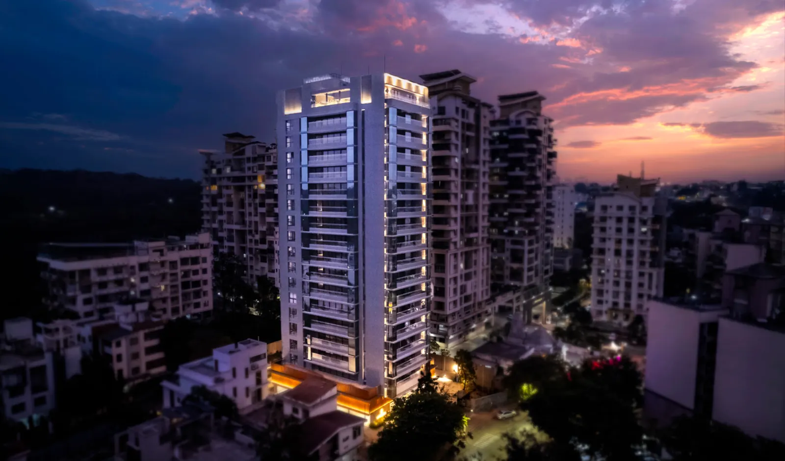The Attalika tower lit at night, seen from the air over Bibwewadi
